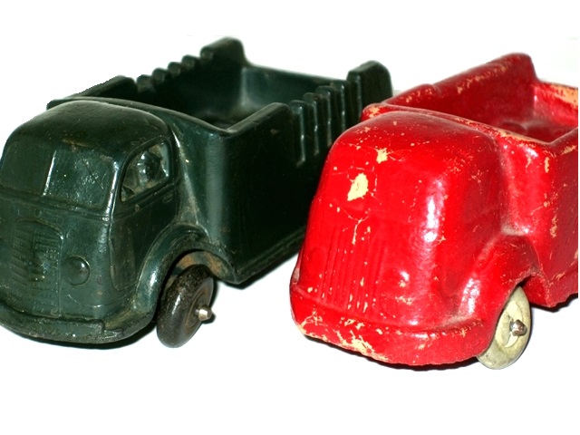 Side by side views of rubber and sawdust trucks.