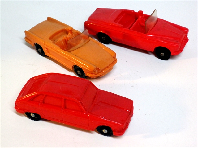 Tomte Laerdahl's red Renault R16 is shown below an orange Renault Floride roadster which in turn is below a red Peugeot 403 convertible, all with black wheels, all approximately 4 inches long.