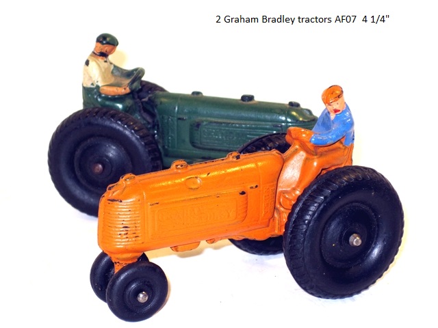 Two Graham Bradley tractors, one green and one yellow, with drivers. AF07
