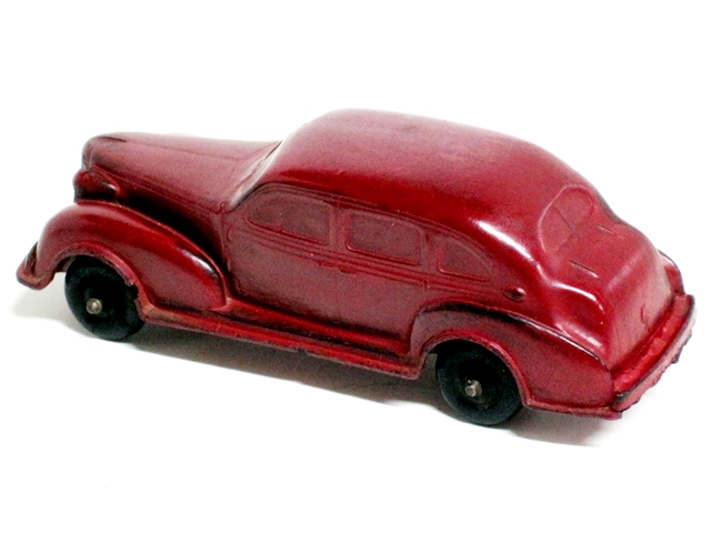 The red 1937 Oldsmobile 4-door viewed from the upper right front quarter.