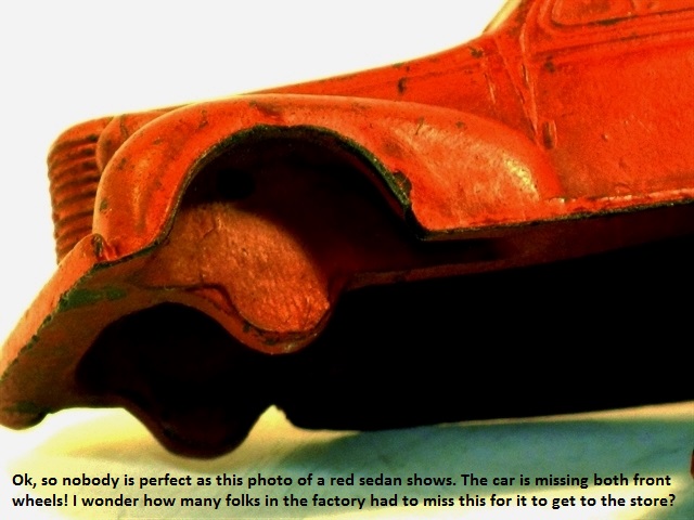 The factory failed to drill for and install axles and wheels on this orange red sedan