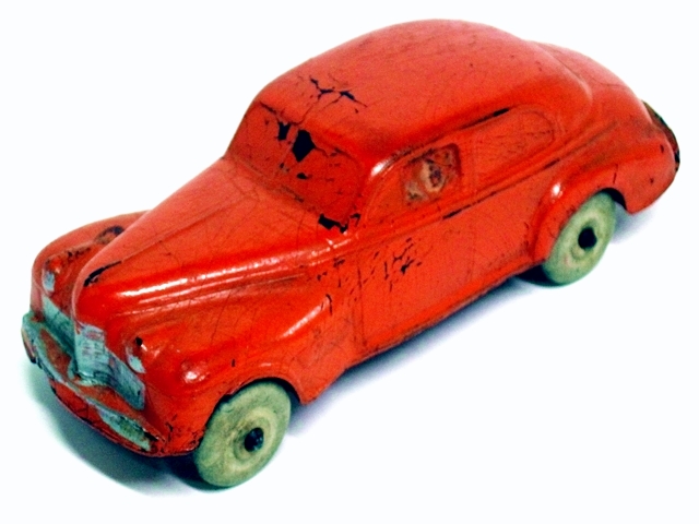 An orange 1940 Oldsmobile with open fenders and silver grill.