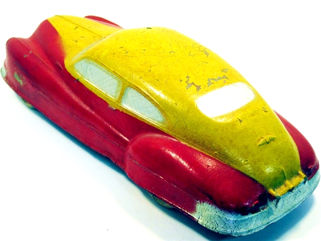 The same yellow over red Buick, seen from the driver's side rear quarter.