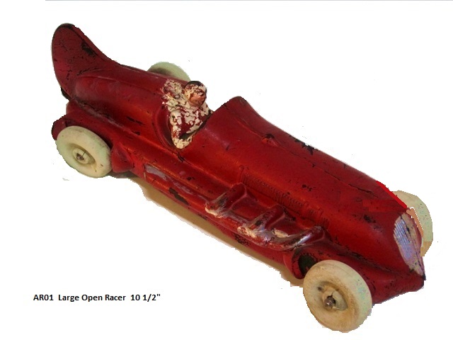 This, the first of the Auburn race cars, is the 300 lb elephant in the room. It just dominates all the other auburn racers. It is 10 1/2 inches long, red with silver exhaust and grill, and a driver all in white. It looks to me that the driver has a scarf blowing out behind him like a WWI flying ace. The body is narrow and rounded at the grill, then opens over the engine, and begins to narrow again behind the driver's cockpit. There is a large, rounded vertical fin at the very rear of the car. The large tires are white.