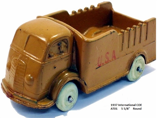 Front quarter view of the Army brown stake truck with round bumper.