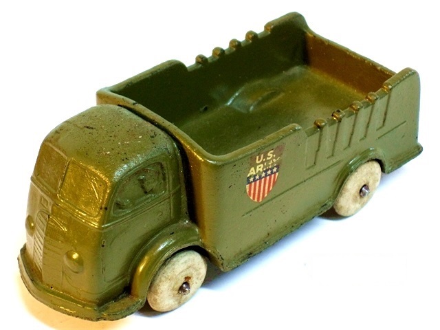 Here we have an army green cab-over truck with a shield decal. At the top, the words U.S. Army. Just below it, a narrow blue bar with five white stars. The bottom of the shield has six narrow red vertial bars divided by white.