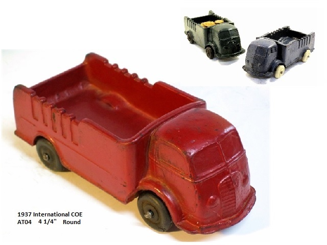 This is a front quarter view of a red, medium size cabover with white tires. In the upper right corner is a pair of coe's, one green and one blue.