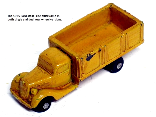 This is the shiny, bright yellow truck with dual wheels showing the driver's side.