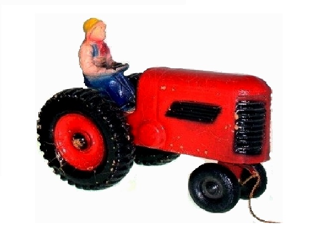 A large composition tractor offered circa 1945. This tractor was offered with Glolite toys in a catalog but the maker may not be Glolite. It looks like it might be made of pressed sawdust, and it has aged remarkably well -- a favorite of mine!