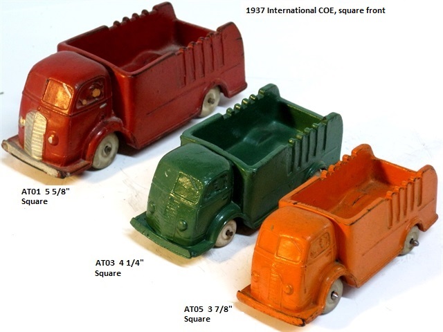 Here we see a front quarter view of a large red, medium green, and small orange square front cabover trucks. All three have white tires. The medium truck is 4 1/4 inches long, and the small is 3 7/8 inches long.