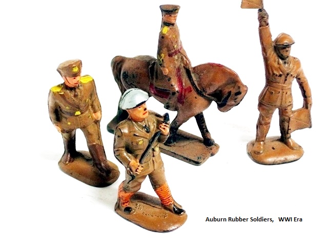 This is a grouping of WWI era army command figures. There is a walking officer with swagger stick, an officer on horseback, a marching soldier and a soldier with signal flags. Coat and tie as well as leggigs were apparently de riguer for Auburn WWI soldiers except command figures.They wear knee high boots and officers' hats. The flagman is also an exception as he wears full length pants without leggings. His flags are divided in half diagonally in red and white.