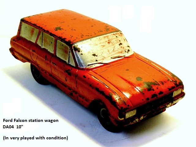 A very battered 10 inch, red Ford Falcon 4 door wagon shows the lovely lines of the model despite years of hard use, here seen from the right front quarter. The absence of the large, ugly rubber bumper guards of later years are thankfully absent from this model at both front and rear.