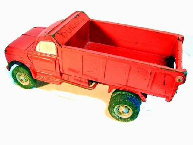 Another view of the dump truck, this of the left side with the bed in the raised position.