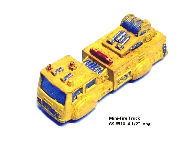The fire truck is small, about four inches long but quite detailed from the two hose reels, top mounted water cannons, and dash panel water control gauges to bubble light, light bar, and hose connections. There are two large sirens mounted atop the cab, which is squarish and has lots of 'glass'. It is bright yellow but, like all my yellow Garretts, always looks filthy because one cannot get it clean. This view is from the left front quarter.