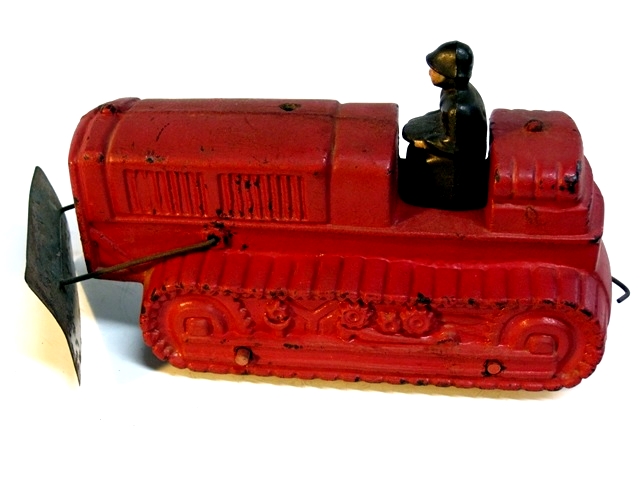 This view is of the left side. The tips of the wooden axles can be seen where they come through the dozer tracks, and the wire hook in the back can be seen.