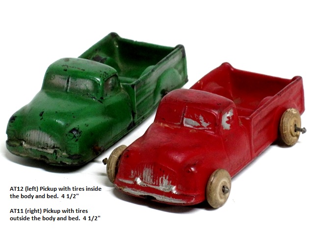 Two Aurburn pickkup trucks, one green with tires inside the truck body, 
				one red with tires outside the truck body. The trucks are both 4 1/2 inches long.