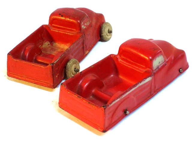 Another phto of the auburn pickup trucks, these both red, shown from the rear and above.