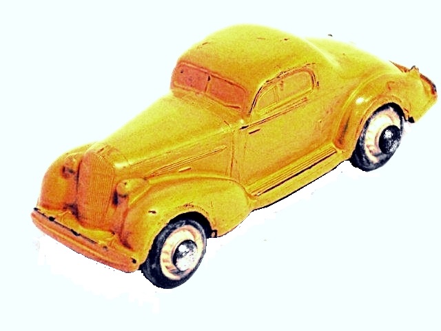 This is the Rainbow coupe,
			in yellow, shown from the left front. The coupe, at 3 3/4 inches long, is quite a sturdy toy with very good paint.