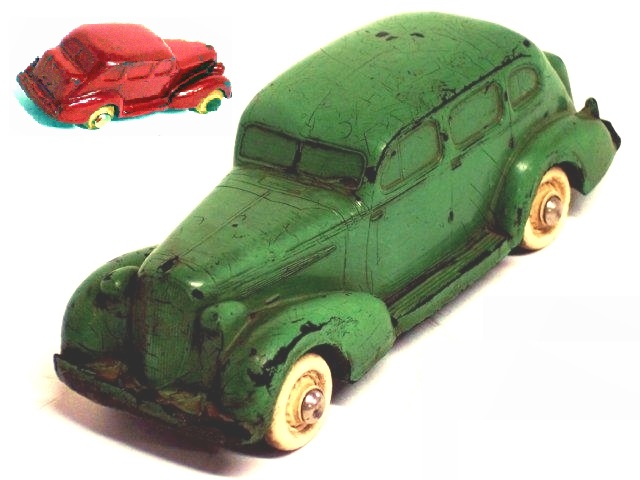 This is the large Rainbow
			4-door sedan in dark green, shown from the left front. It is quite a sturdy toy with very good paint.