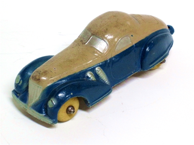 1936 Supercharged Coupe in light tan over blue viewed from the left front. The supercharged coupes are 4 inches long. Pre-WW2 versions are solid color, post-war are both solids and two-tones. Some, like this one, have trailer hitches.