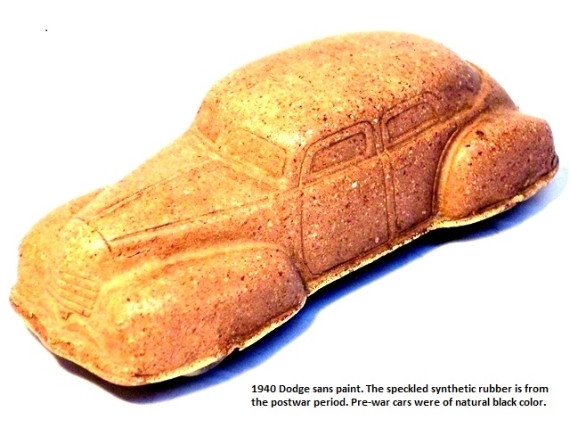 A 1940 Dodge without paint viewed from the left front. It is reddish-tan in color. The speckled rubber reveals the car to be postwar. Pre-war cars were made of natural black rubber.