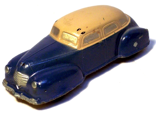 A dark blue 1940 Dodge 4 door sedan with a light beige top, viewed from the front quarter.