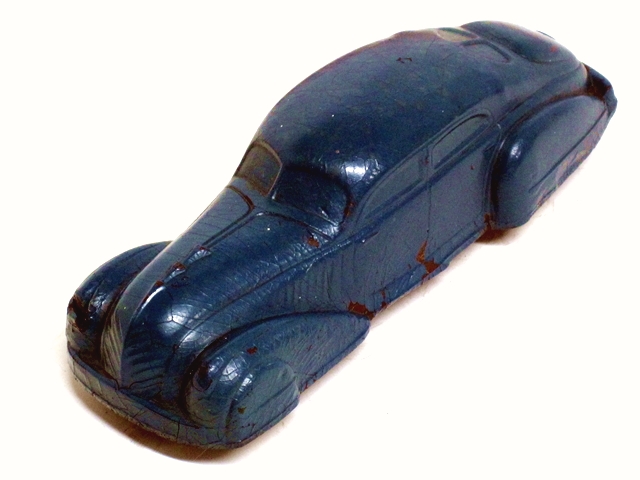 A deep blue Teardrop Sedan viewed from the left front.