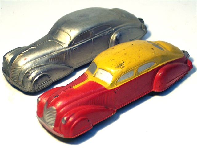 A pair of 1936 Teardrop Sedans, one solid silver, one yellow over red.