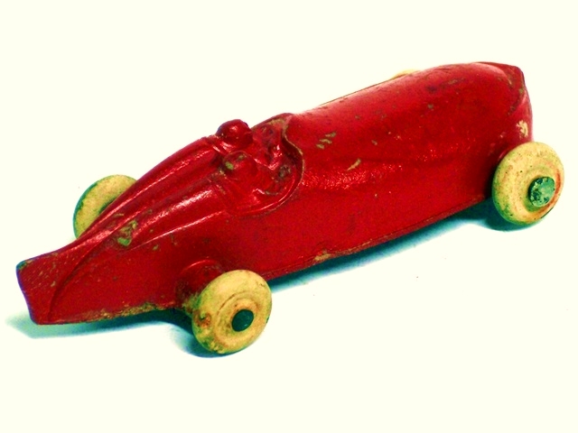 The right front quarter view of the red open race car.