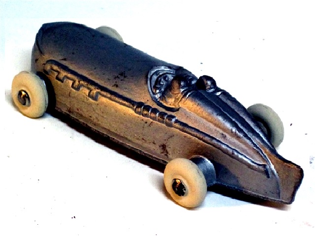 The right front quarter view of the silver race car.