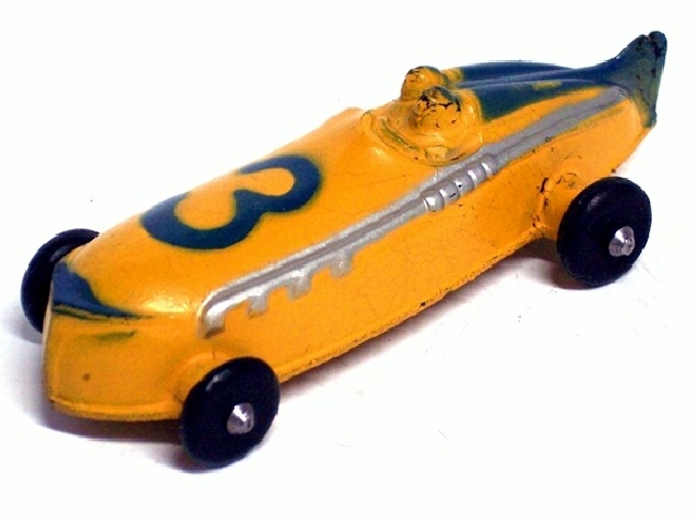 A yellow 2-man race car with blue trim, small black tires, the number 3 atop the hood,a promo, Compliments of Royal Rubber Company, on the right front side. Viewed from the front quarter