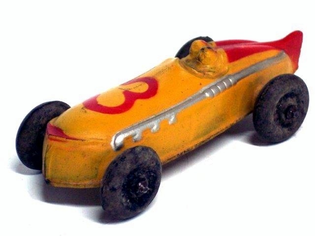 This is a front quarter view of a yellow Sun race car with red trim, number 3, large black tires. All of the exhaust pipes come out on the driver side. The car is four and a quarter inches long.