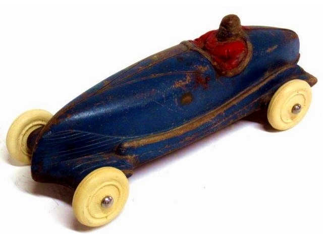 A Sun open racer, six and three quarter inches long, painted blue. The driver is painted red and may not be the original color. The large white tires look like replacements.