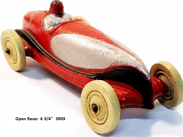 Another view of an open racer, this one painted red with a large silver, long, teardrop-shaped design that forms an elongated butterfly running from the top front center over to the sides.