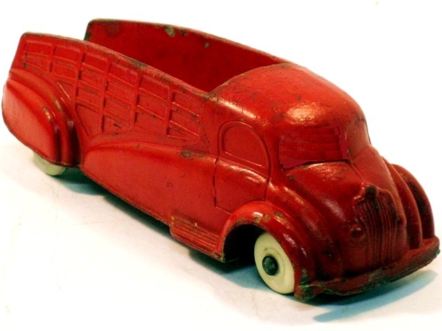 A solid red pickup truck, viewed from the front quarter.