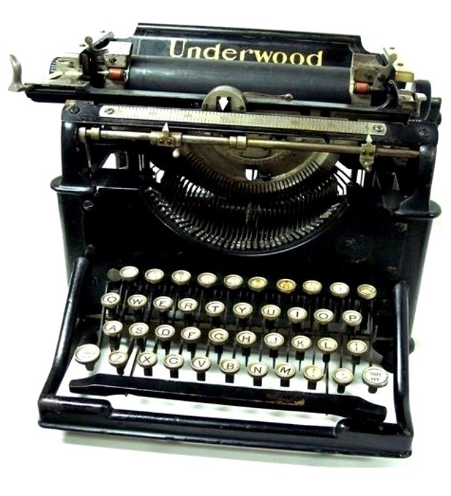In this frontal view, the Underwood 1's simplicity shows in the overall straightforward layout of the typewriter. A large paper tray with Underwood in large, stencilled gold letters highlighted by two pencil thin lines of gold and copper striping (the only striping anywhere on the machine), two platen twirlers, the line-feed and carriage return arm on the left, two spring-loaded pressure rollers, and an index with position-indicating pointer manage paper handling. Left and right margin settings are managed by adjustable stops which slide on a bar across the front of the typewriter, in front of the index. These are moved by pushing the small, round and pointed levers to the left and sliding the stops. An arm actuated by a button on the front of the typewriter next to the left shift key lever releases the carriage to allow typing beyond the stops.The keys are bright rimmed with black lettering on a white background, and a long, wide space bar completes the keyboard layout. The serial number, 10249, is located atop the frame member just below and to the front of the right hand platen twirler.