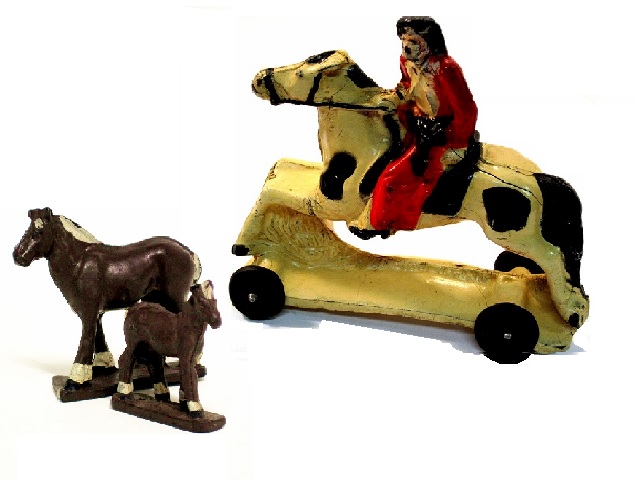 Pair of sturdy farm horses and a cowboy on a rearing horse, wearing red chaps and vest, brown hat and boots, and shirt and trousers. His horse, a white paint has large black spots, mane and tail, and sports a black western saddle. Looks, to me, to be running.